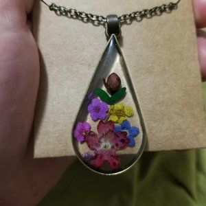 Dried pressed flowers in glass necklace